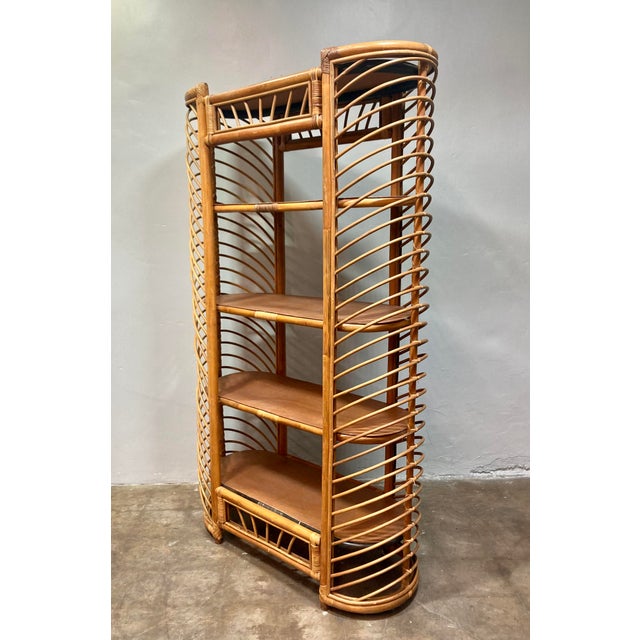 Vintage 1970's oblong ribbed rattan etagere shelving unit. Unique "rib-like" side structure and 4 extra wide shelves....