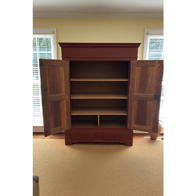 Lovely painted wardrobe featuring a deep rust exterior and two pastel bouquets painted on each door. Good condition with a...