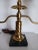 Mid century French Empire Revival Brass Table Lamp . Design elements include candelabra style arms, black marble base, and...