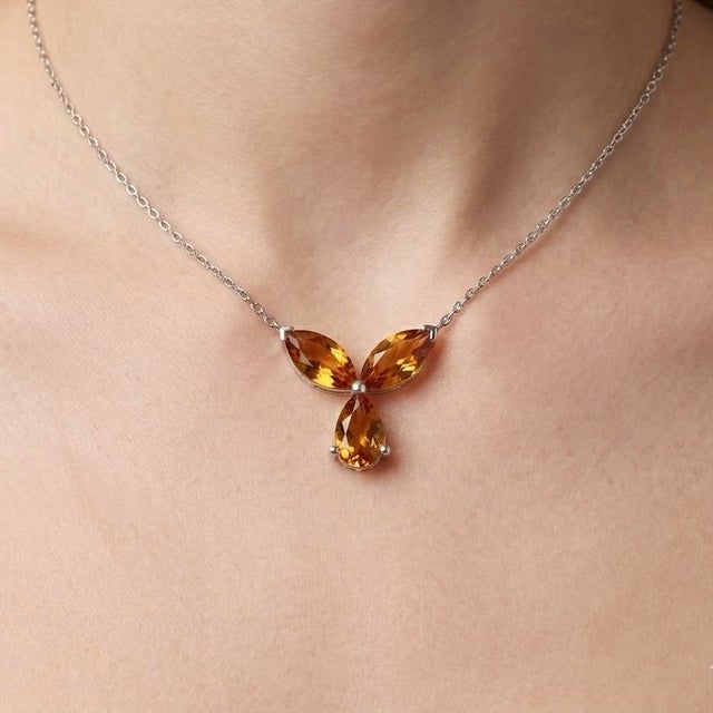 Radiating warmth and elegance, this beautifully crafted pendant features a stunning arrangement of Citrine gemstones,...