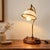 This elegant table lamp by Ryckaert, from the Louisiane collection, stylishly reinterprets the spirit of vintage desk...