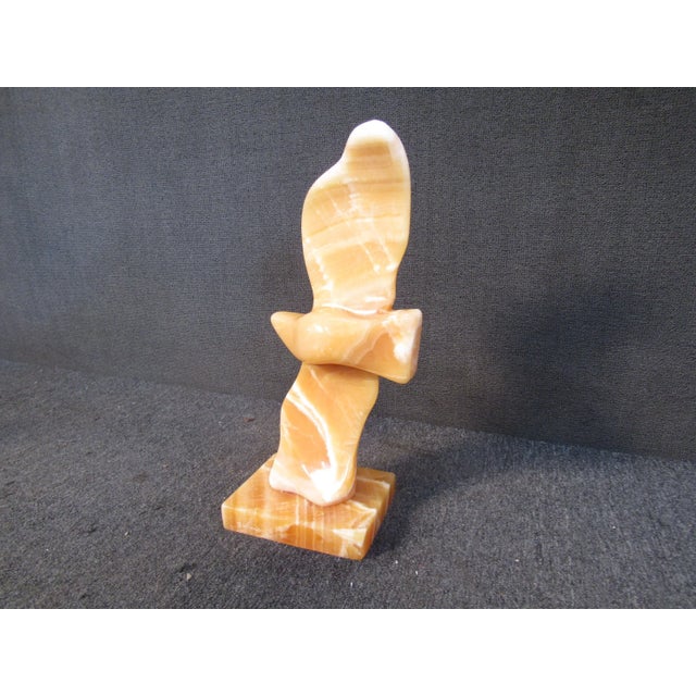 This large tabletop sculpture features an abstracted bird form in a red shade of marble. The sculpture is signed...