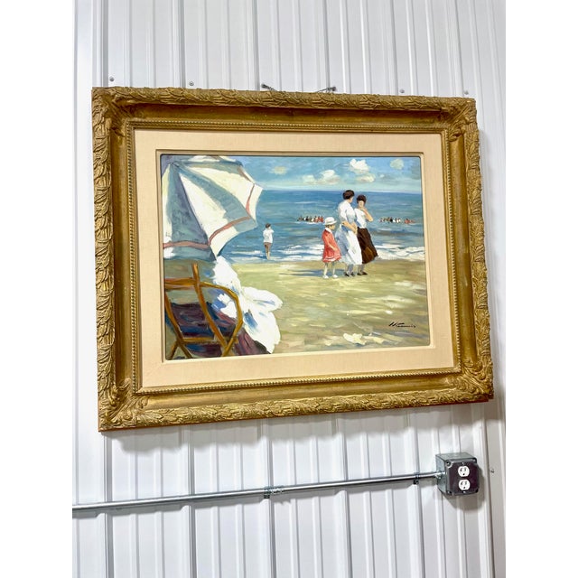 A charming original, custom framed oil painting of a seaside vista with a mother and daughter at the beach with a beach...