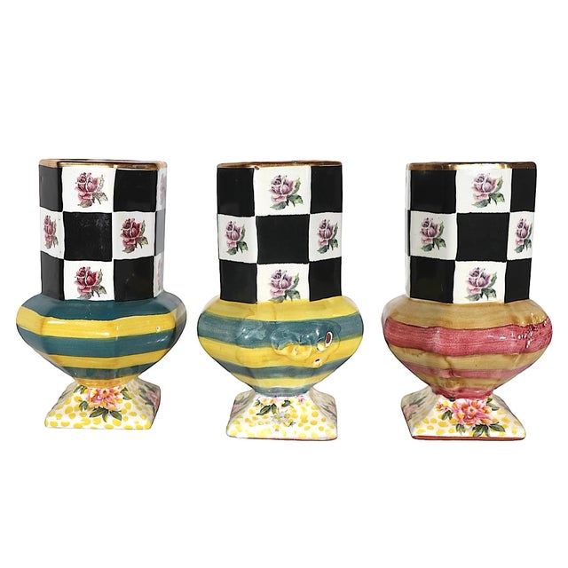 Lot of three McKenzie Childs Torquay Palm and Devon Clay pottery pedestal coffee, tea mugs. All three are in very good,...