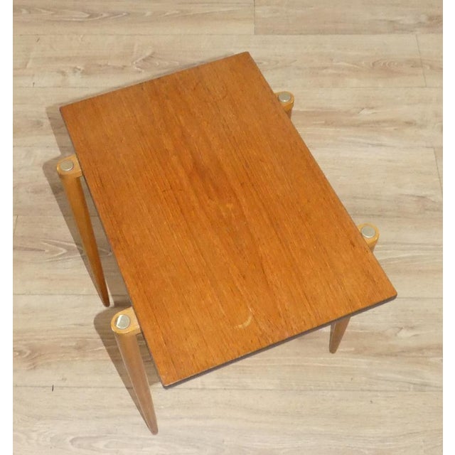 This delicate little table on the exposed needle-fine conical legs is part of a classic nesting table from Opal Möbel: 3...