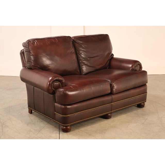 High Quality American Made Leather Two-Seat Sofa or Loveseat with Rolled Arms and Brass Tack Trim, Mounted on Bun Feet