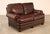 High Quality American Made Leather Two-Seat Sofa or Loveseat with Rolled Arms and Brass Tack Trim, Mounted on Bun Feet