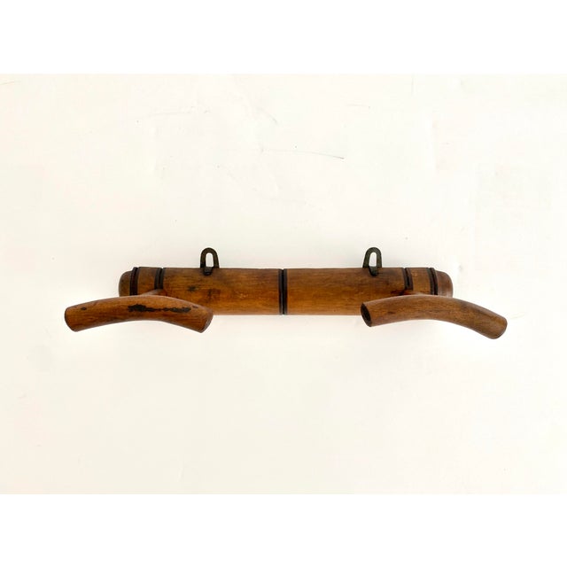 This small French hat or coat rack is wall mounted and rather uncommon in its configuration. Provincial in its wood finish...