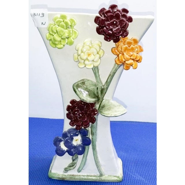 Fine artsy craftsy ceramic vase by Dana Gibson with applied flowers, thin for shallow space placement.