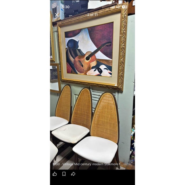 Vintage Mid-Century Modern chairs characterized by their distinctive tall, exaggerated oval "atomic" backrests. While the...