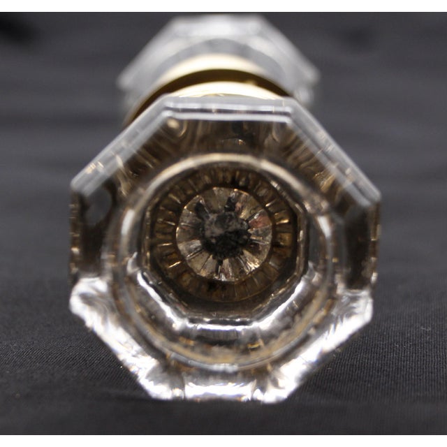 Vintage octagon clear glass door knob set with a bullet center and brass rosettes. Good condition with appropriate wear...