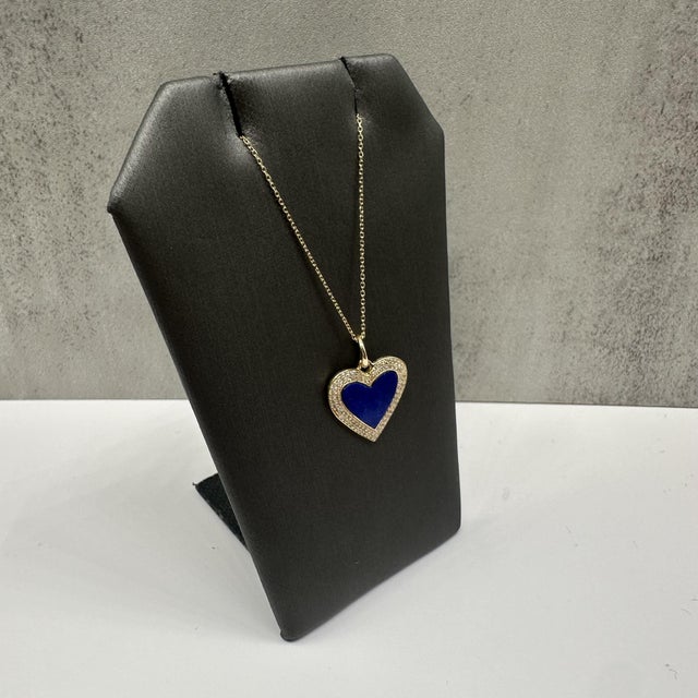 This beautiful diamond and lapis heart pendant necklace in 14kt yellow gold features a rich 1.02 carats total weight of...