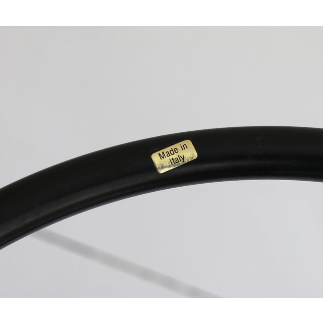 Circular glass and metal side table stamped Made in Italy.