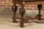 An English oak center table from the 19th century with star-shaped marquetry, carved apron, turned baluster legs and...