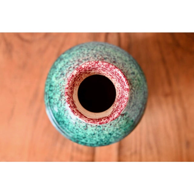 This large, bulbous vase is a product of the Accolay potters. Its distinctive speckled glaze, a gradient from green to...
