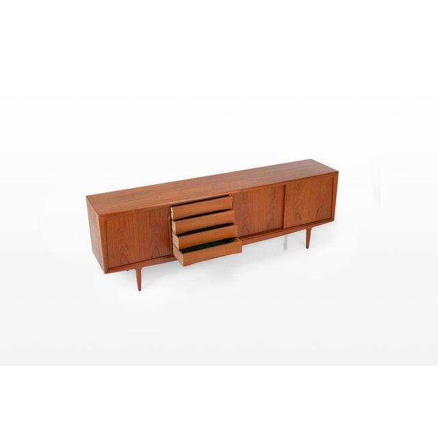 Danish teak sideboard designed in the 1960s and produced by Axel Christensen Odder (ACO Møbler). This refined mid-century...