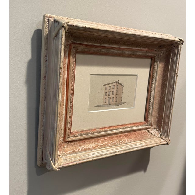 An antique drawing in watercolor and ink of an architectural study of a building. Framed in a white washed 1860s sand...