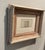 An antique drawing in watercolor and ink of an architectural study of a building. Framed in a white washed 1860s sand...