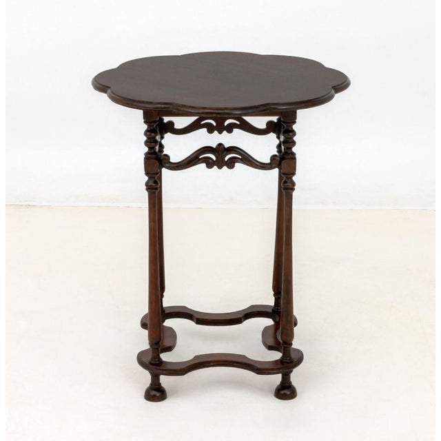 Victorian Style Floriform Top Side Table, with reticulated carved wood scrolling motifs and four supports terminating in...
