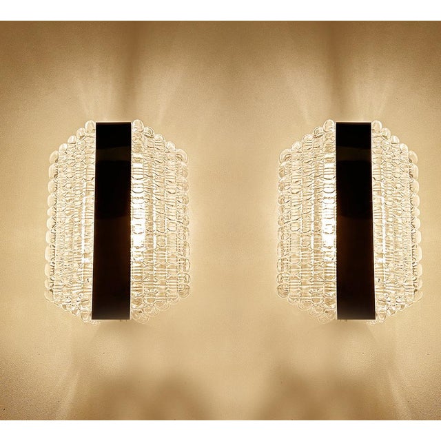 Pair of vintage mid century bubble glass sconces by kaiser , featuring stepped bubble glass shade with a center chrome...