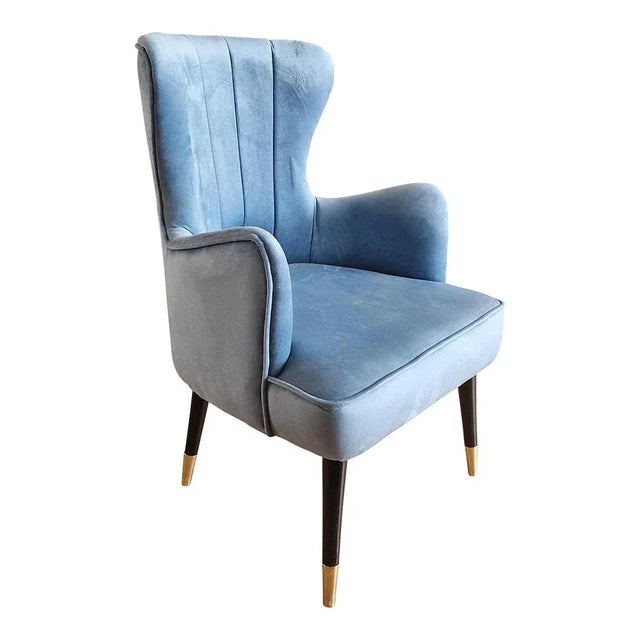 Armchair in light blue velvet with black lacquered wooden feet and brass finish Dimensions (lxpxh) 60x56x86 cm seat height...