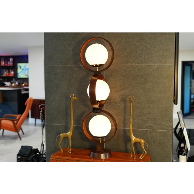 This sculptural Globe Ring Lamp by Modeline is a standout example of classic Mid-Century Modern lighting, combining warm...