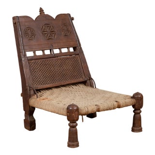 Antique Indian Rustic Low Seat Wooden Chair With Carved Rosettes and Twine Seat For Sale