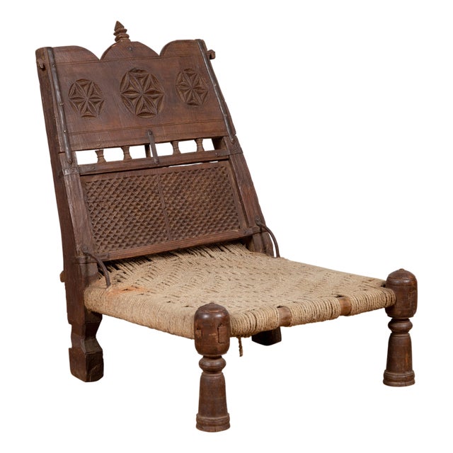 Antique Indian Rustic Low Seat Wooden Chair With Carved Rosettes and Twine Seat For Sale