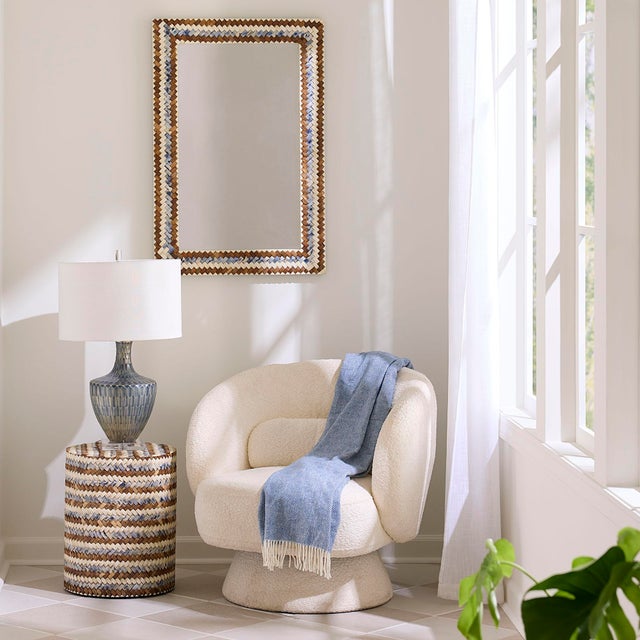 Crafted from natural bone and inlaid with exceptional care, this decorative mirror shimmers with radiant texture and...