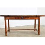A 19th century farmhouse table, whose robust design is a practical solution for the modern kitchen to pivot between dining...