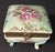 Vintage porcelain jewelry/trinket box. Hand painted light green in color with pink & green floral motif and gold...