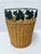 Vintage woven wicker waste basket with metal leaves accent. Measures 8 1/2” wide x 10 1/2” tall.