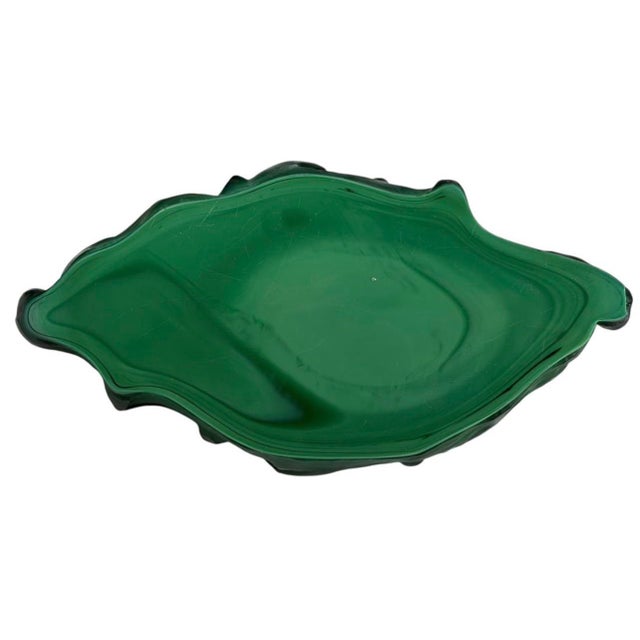 Art Deco malachite glass fish bowl. Molded in translucent green malachite glass, the bowl is formed as a stylized fish...
