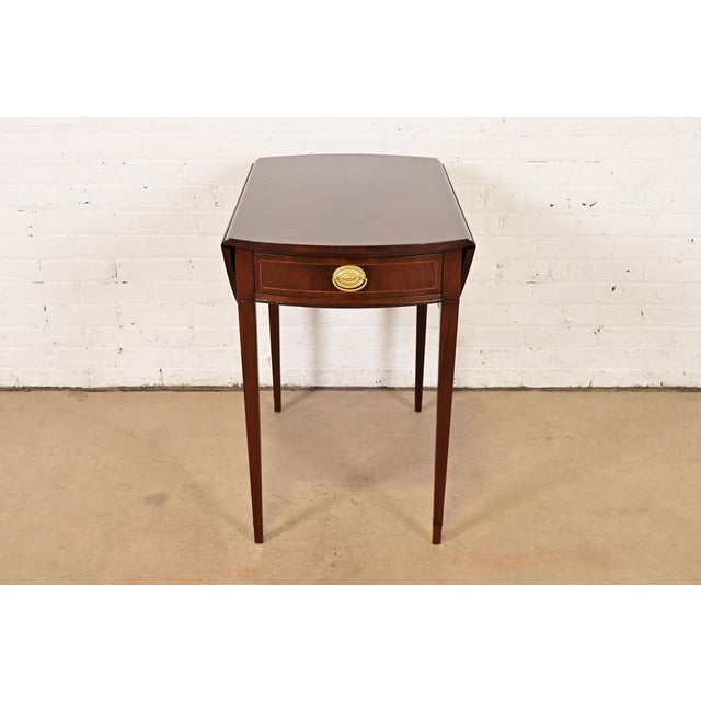A gorgeous Georgian or Regency style Pembroke nightstand, tea table, or side table By Baker Furniture USA, Circa 1940s...