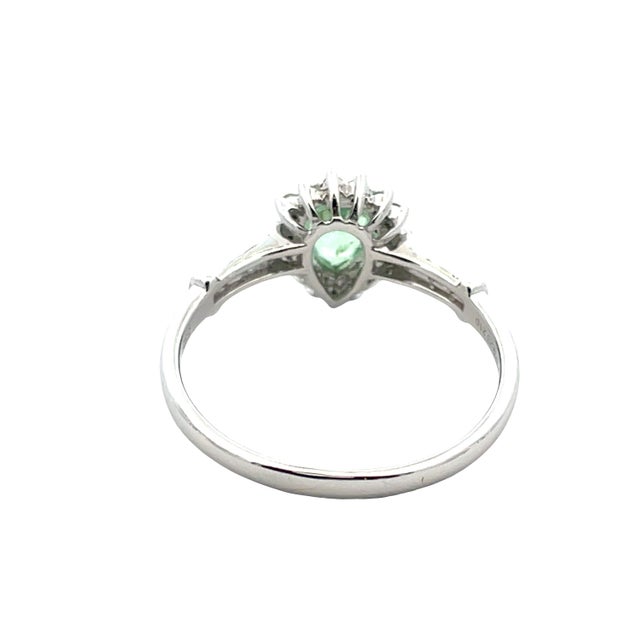 Elegant and timeless, this ring is crafted in 14K white gold featuring a vibrant pear-shaped green tourmaline center...