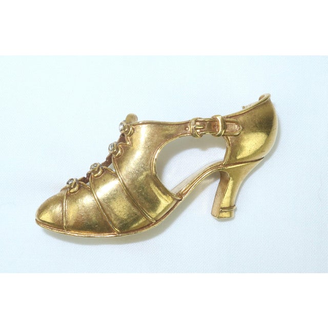 1970's Metropolitan Museum of Art gilded brass brooch in the form of an Art Deco flapper shoe complete with a detailed...