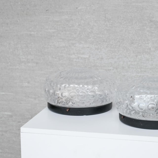 a set of three glass and metal wall lights. france, c1970s. bubble style diffused glass shade. since re-wired and pat...