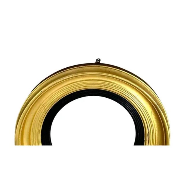 Early 19th Century Regency Carved Giltwood Bullseye Convex Mirror. Mirror features a circular frame with a classical...