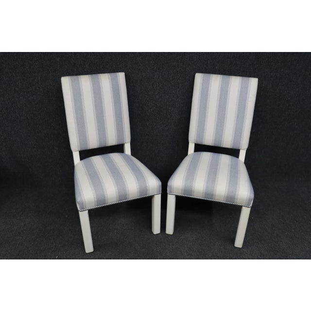A pair of Ethan Allen side chairs , shabby chic style , white painted frames with off white and blue stripped fabric