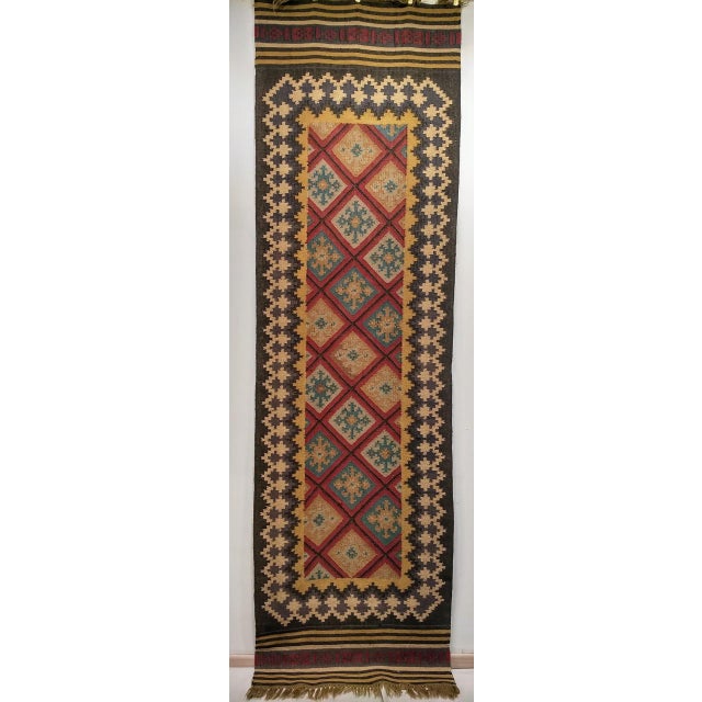 Discover the vibrant artistry of Anatolian weaving with this captivating Vintage Turkish Kilim Runner, dating from the 3rd...
