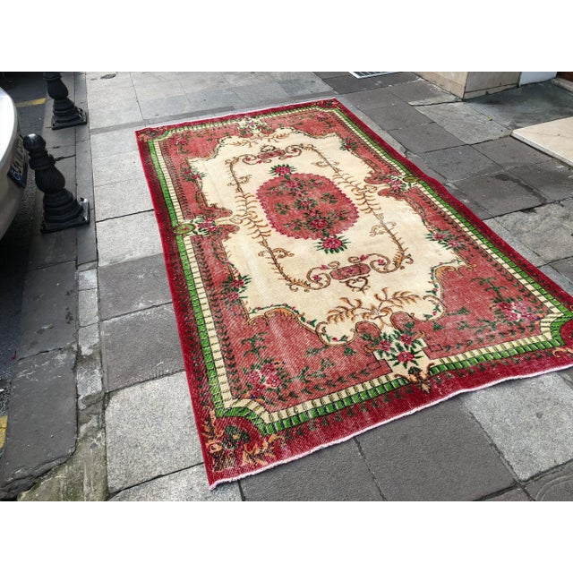 This is a vintage Turkish Oushak rug from the 1960s. The piece was hand-knotted.