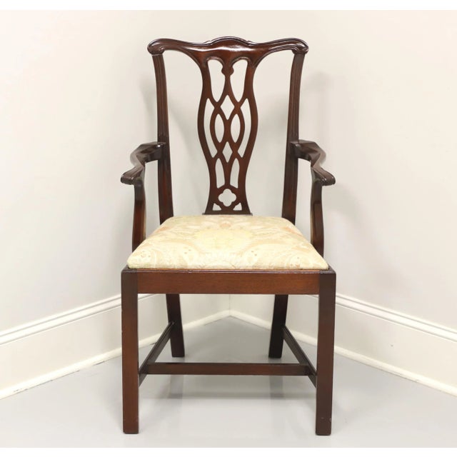 A vintage Chippendale style armchair, unbranded. Solid mahogany with carved crest rail, back splat, curved arms, straight...