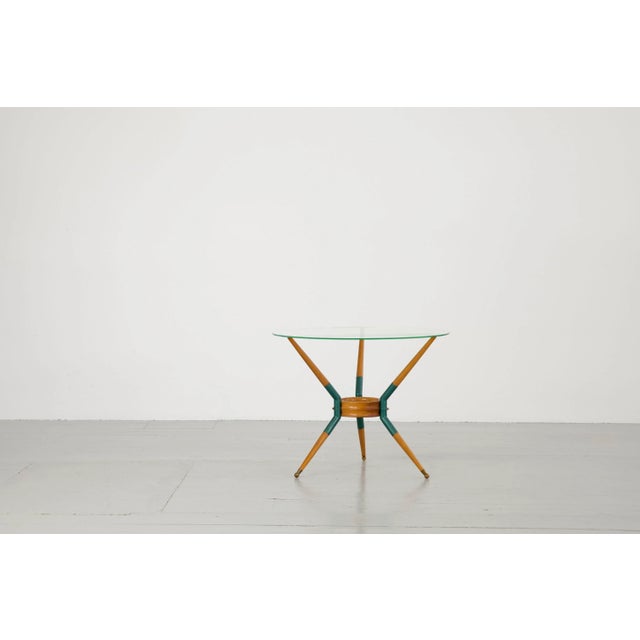 This elegant sofa table was made in Italy in the 1950s. The round glass top is supported by three, beautifully finished...