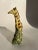 A single ceramic figurine of a giraffe.