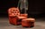 Substantial lounge chair and ottoman set upholstered in warm saddle-toned leather, featuring a deeply tufted backrest with...