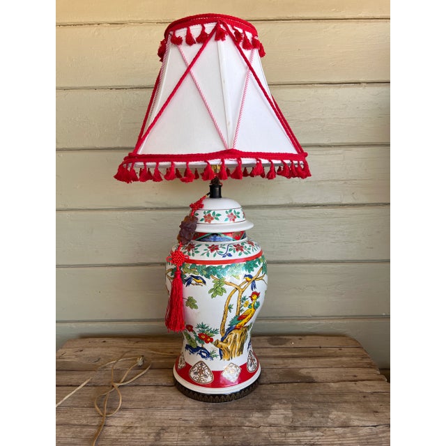 One of a Kind Chinoiserie chic multicolor table lamp. The back and the front of the jar is with colorful peacock images...