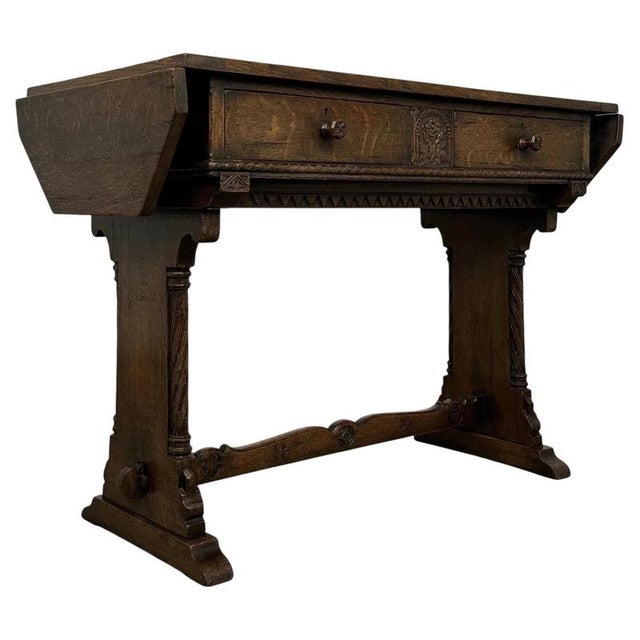 A distinctive early 20th-century English Gothic Revival side table, finely crafted from oak and distinguished by its...
