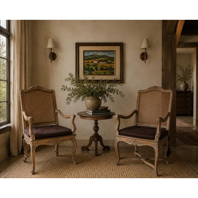 Elegant pair of vintage Hollywood Regency accent armchairs inspired by classic French Louis XV design. Each chair features...