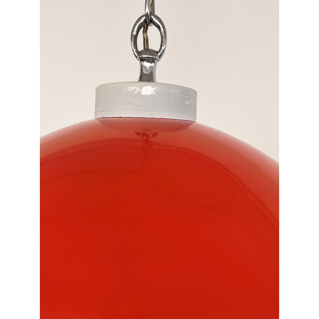Fantastic and rare "Space Age" hanging lamp from Italy's 1980's in shiny red-orange metal with glass spheres of different...