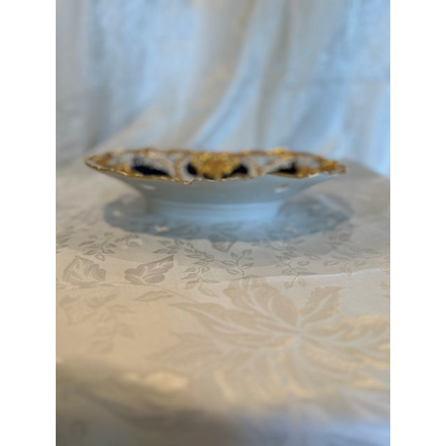 A magnificent antique Meissen porcelain oval centerpiece bowl featuring an exceptionally ornate, deeply scalloped...